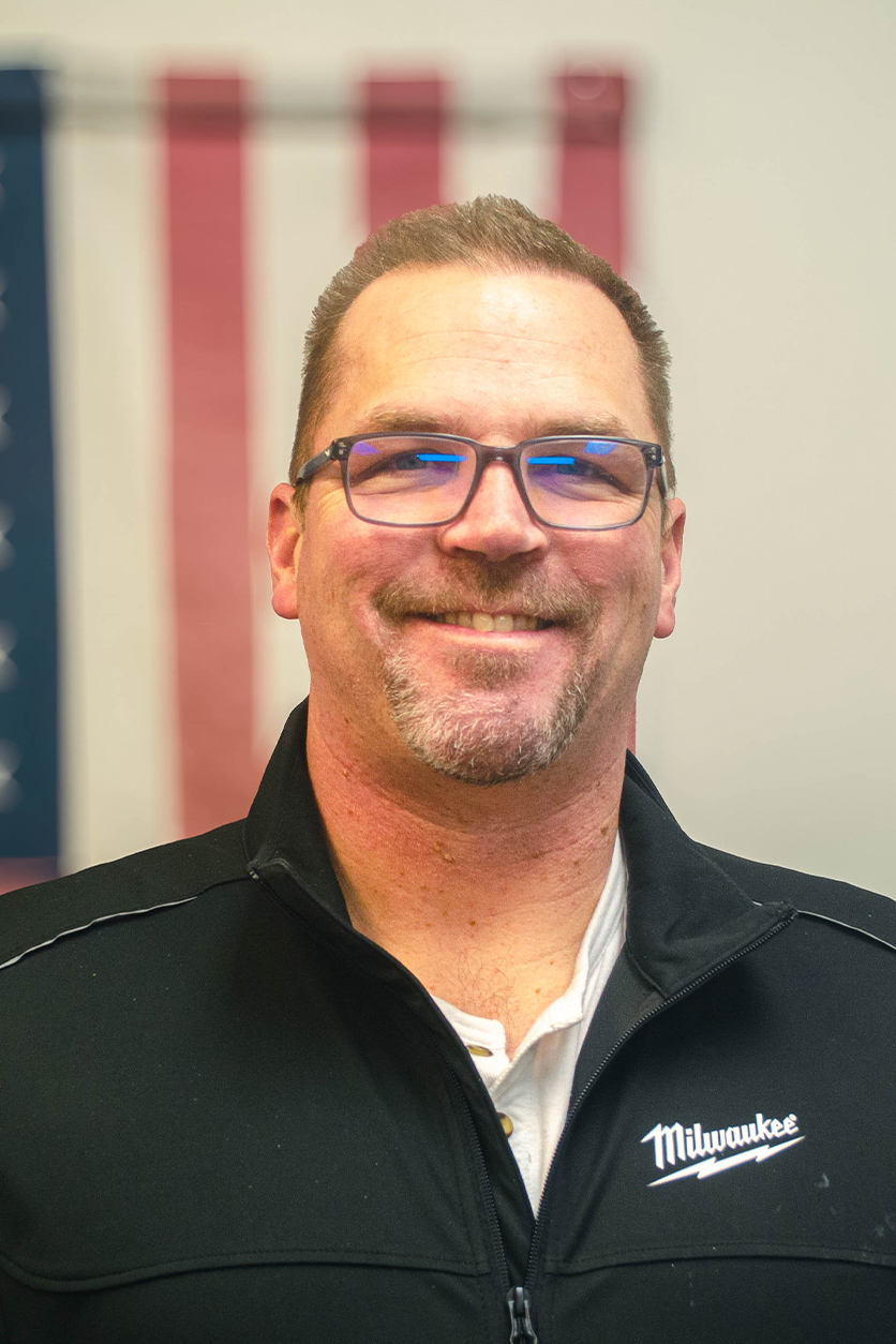 a man wearing glasses and looking at the camera