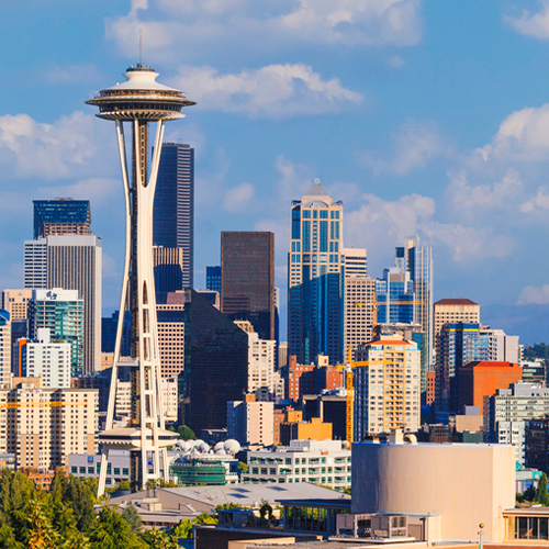 a large city with tall buildings in the background with Space Needle in the background
